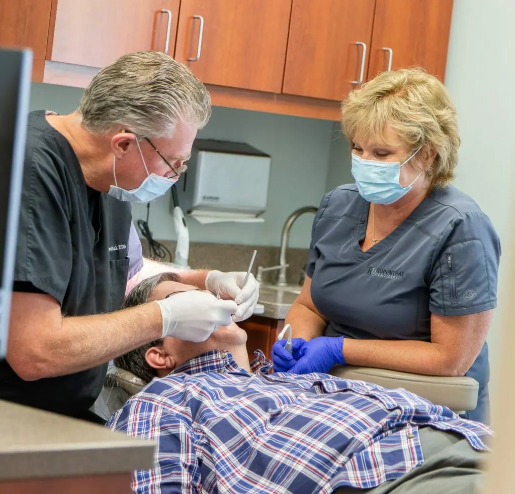 Dentist and assistant giving a dental exam